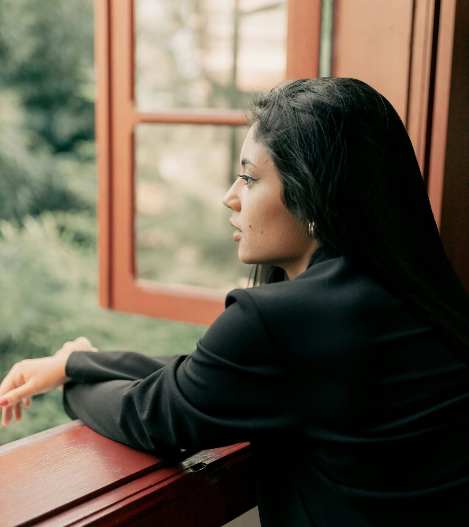Image of woman staring out of room window